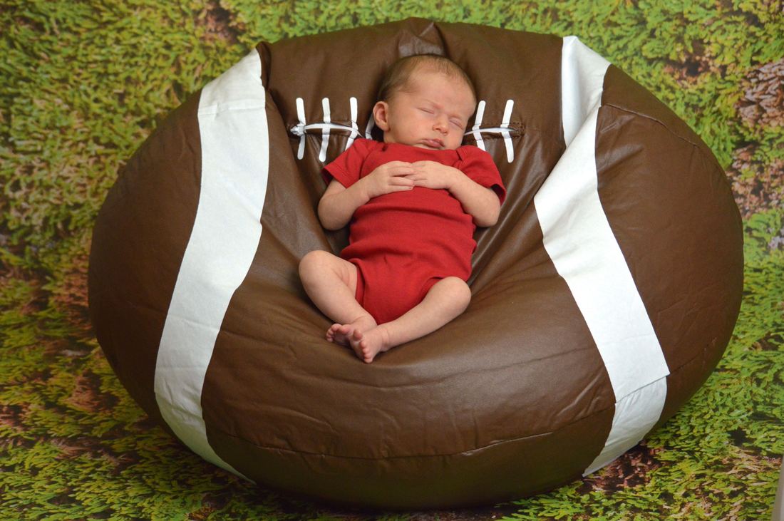 Newborn photography session with baby on a bean bag in our photo studio